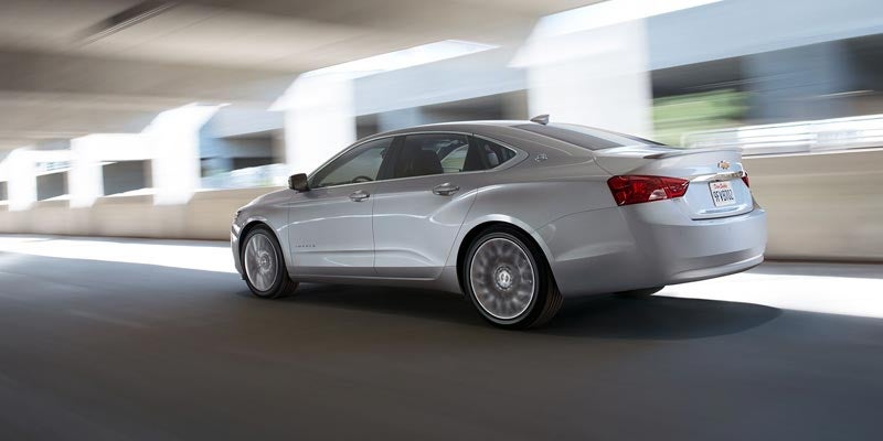 Silver 2020 Chevy Impala driving through parking garage