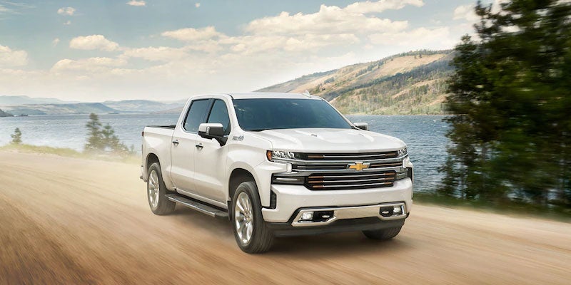 White 2021 Chevy Silverado driving by mountains