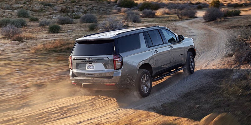 Silver 2021 Chevy Suburban driving through desert