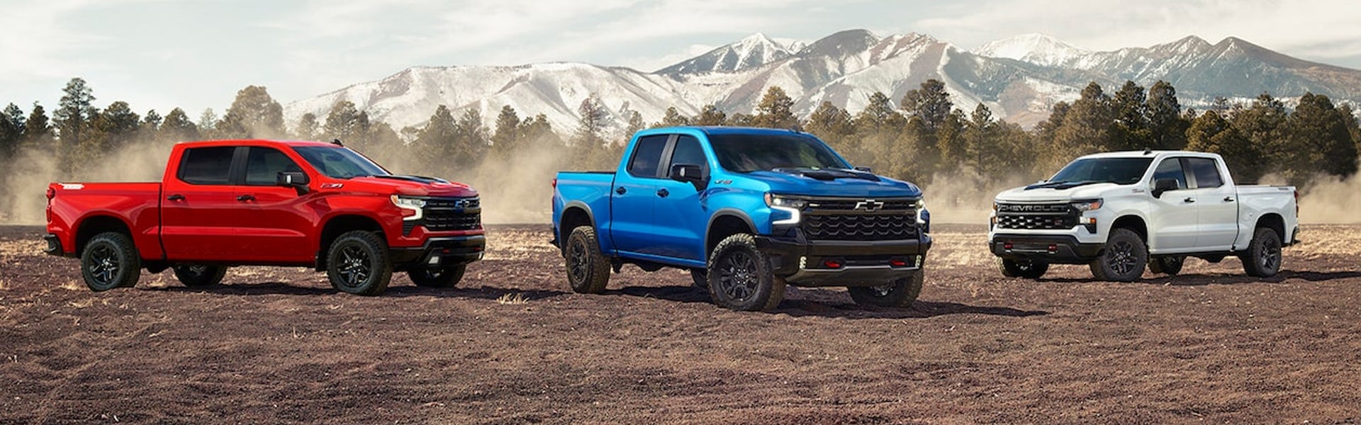 Red, white and blue Chevy Silverado 1500's in the desert mountains