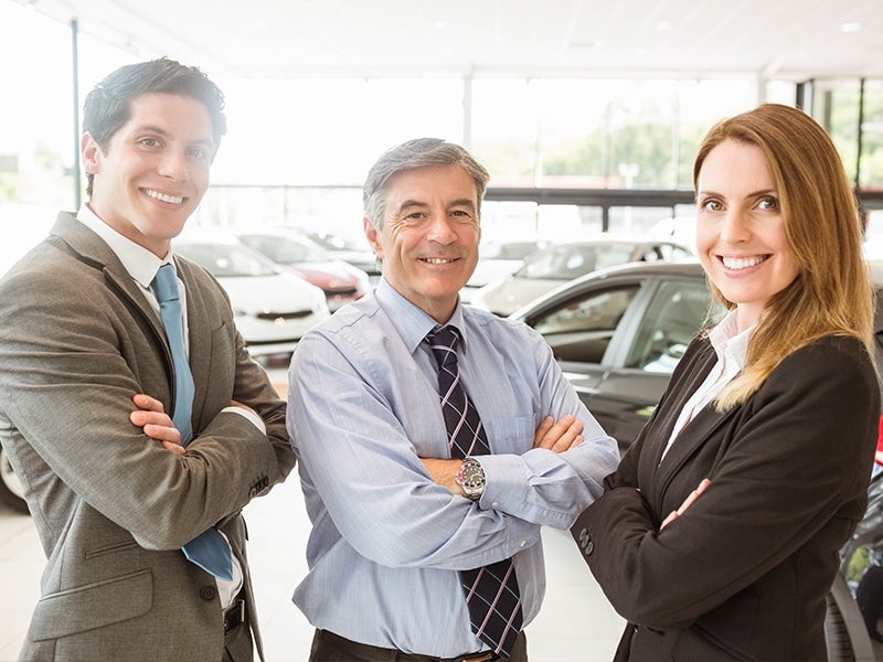 3 salespeople in a showroom